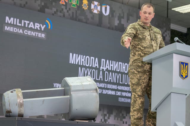 <p>Colonel Mykola Danyliuk points at a dud warhead imitating a nuclear part of a Kh-55SM strategic cruise missile,</p>