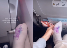 People are divided over this plane passenger waking up to child drawing on her feet