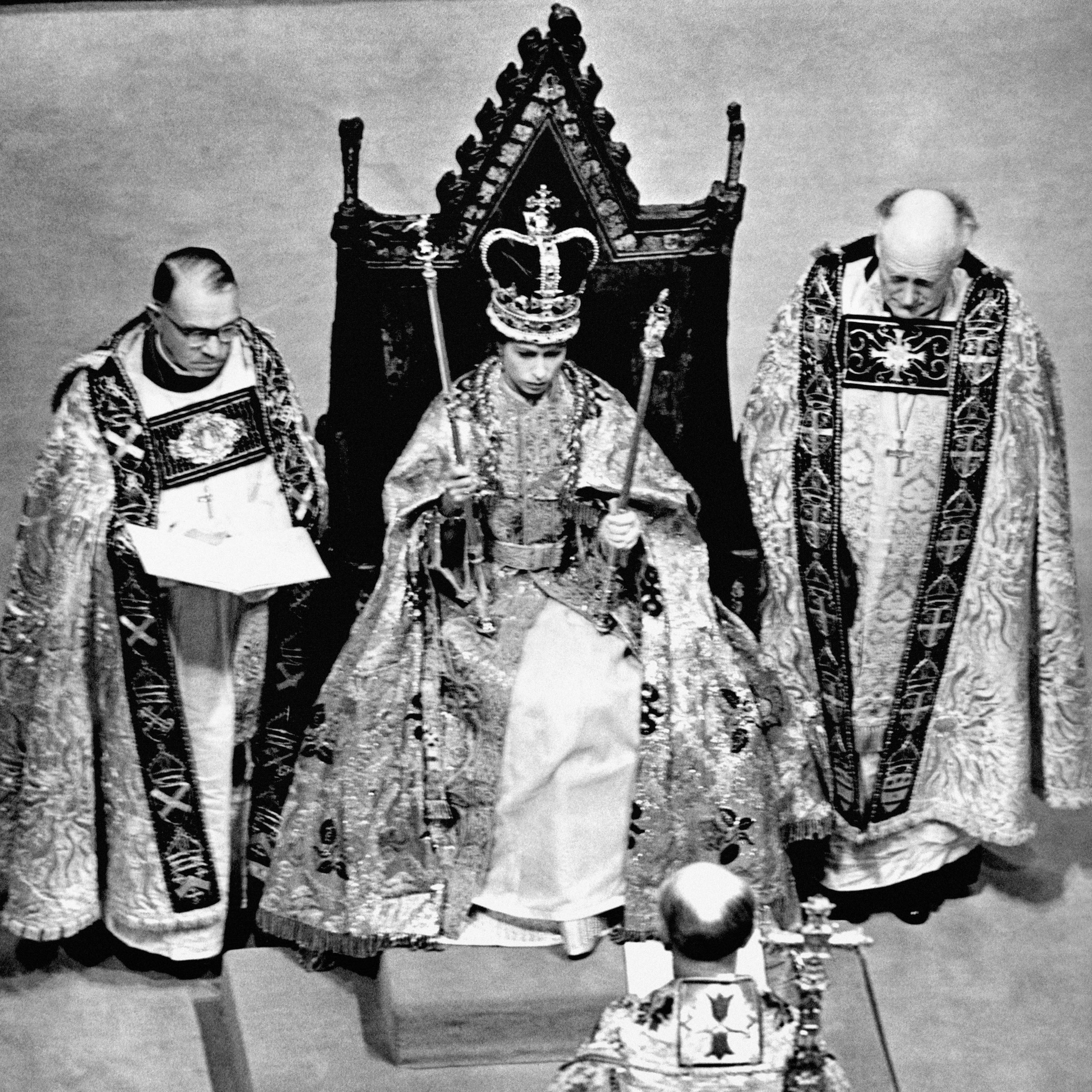 Queen Elizabeth II wearing the St. Edward Crown and carrying the Sceptre and the Rod after her coronation in Westminster Abbey, London
