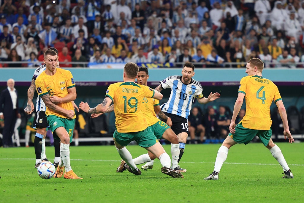 Messi places the opener through a crowd of Australia defenders