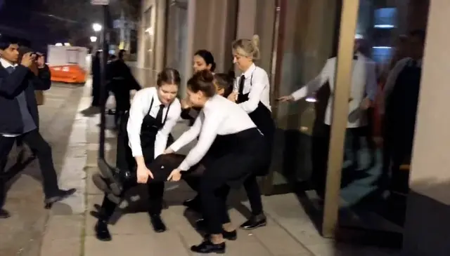 <p>Restaurant staff remove protesters in London</p>