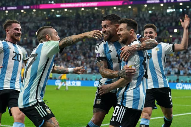 Lionel Messi, second right, is mobbed by his team-mates after scoring Argentina’s opening goal against Australia (Martin Rickett/PA)