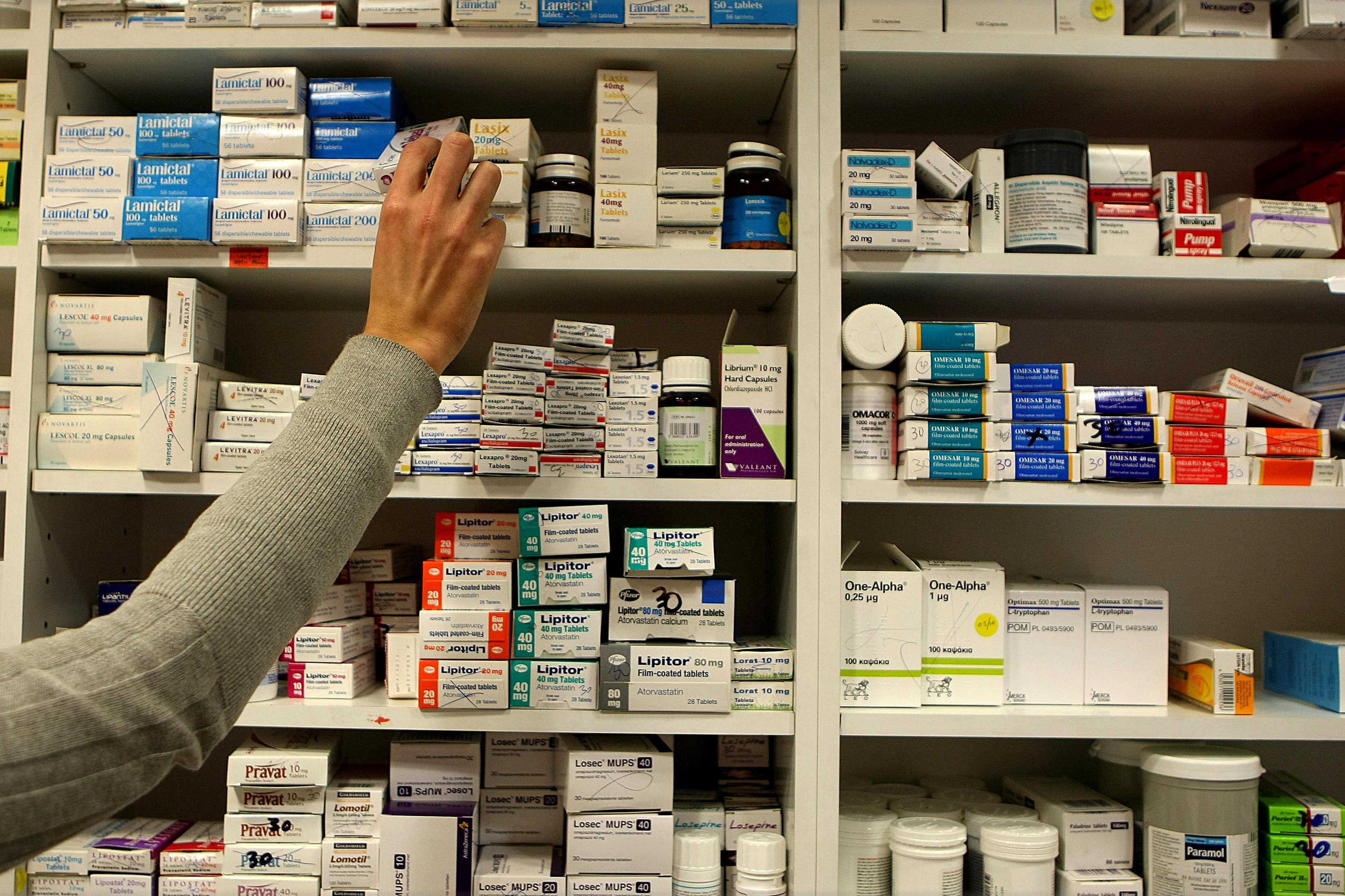 A pharmacist stocks shelves at a chemist in Dublin as Health Minister Mary Harney was urged to be cautious about adding a 50 cent fee on every drug prescribed to a medical card holder as part of a range of health service savings in the Budget.