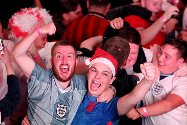 England fans celebrate their second goal at BOXPARK Wembley in London, watch a screening of the FIFA World Cup 2022 Round of Sixteen match between England and Senegal. Picture date: Sunday December 4, 2022.