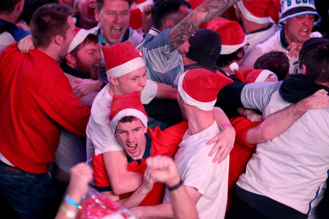 England fans celebrate their second goal of the game at BOXPARK Wembley in London, watch a screening of the FIFA World Cup 2022 Round of Sixteen match between England and Senegal. Picture date: Sunday December 4, 2022.