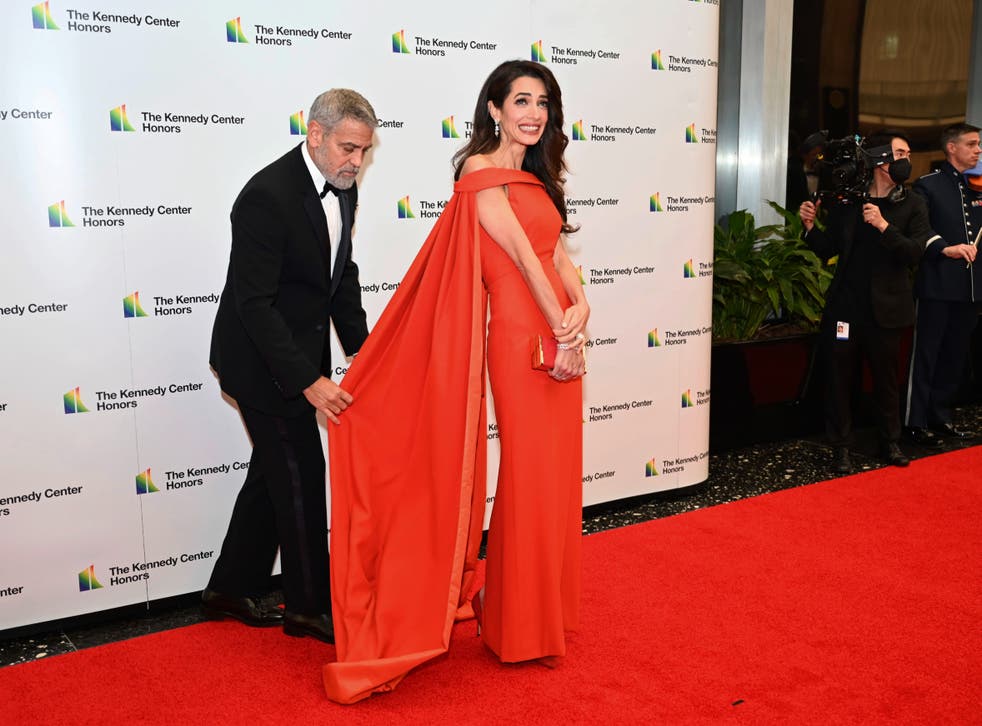 George Clooney fixes wife Amal Clooney’s dress on red carpet at awards