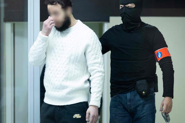 <p>Defendant Salah Abdeslam arrives under police escort for the trial of alleged jihadists</p>
