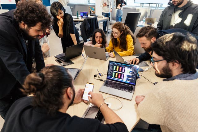 <p>Apple Developer Academy students working together on a project during a developer workshop focussed on accessibility</p>