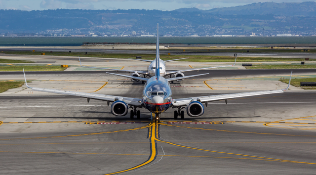 <p>Planes on the runway at San Francisco International Airport. A new study has found that the majority of California’s coastal airports face threat of flooding linked to climate change in the coming decades</p>