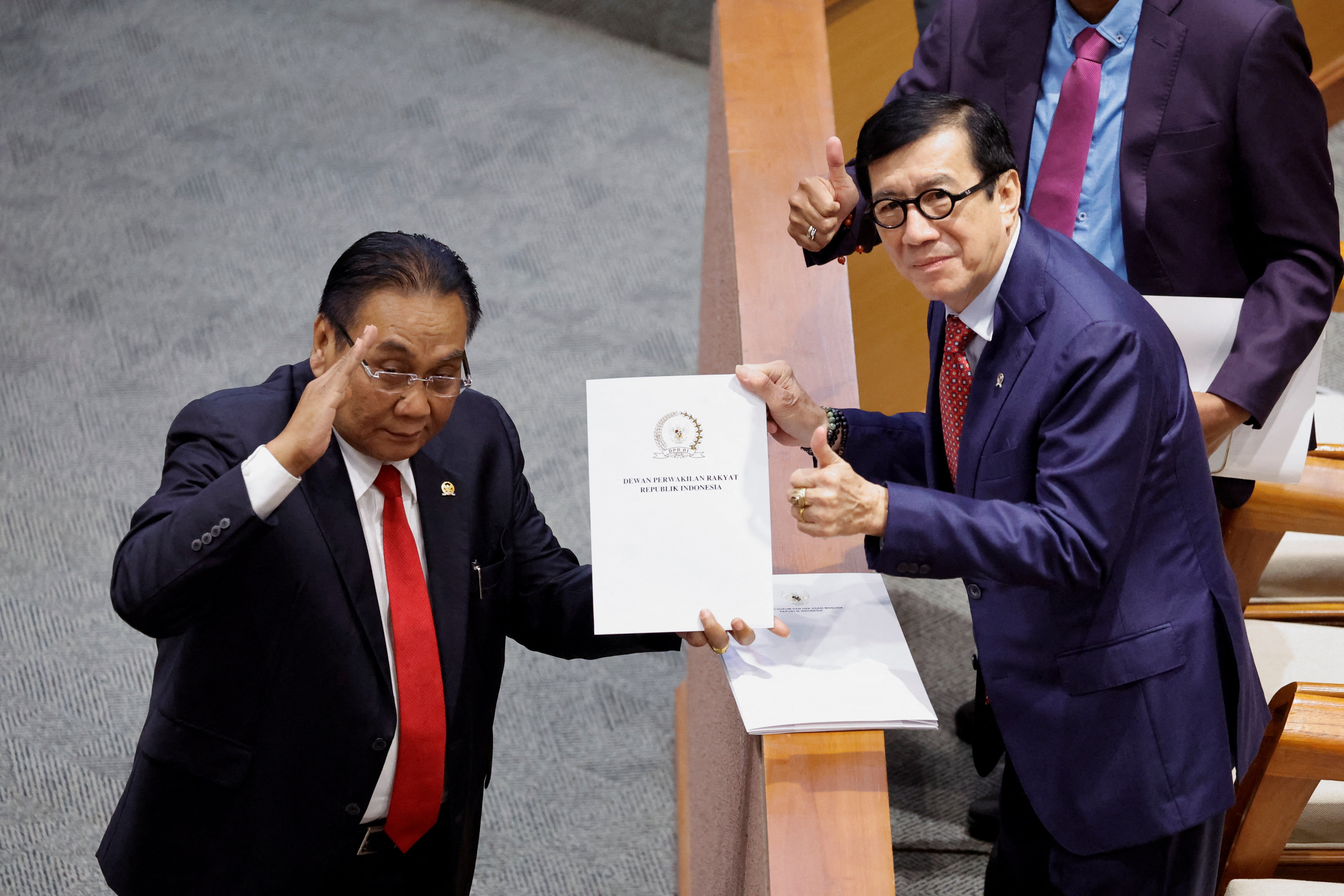 Yasonna Laoly, Indonesian minister of law and human rights, receives the new criminal code report from Bambang Wuryanto