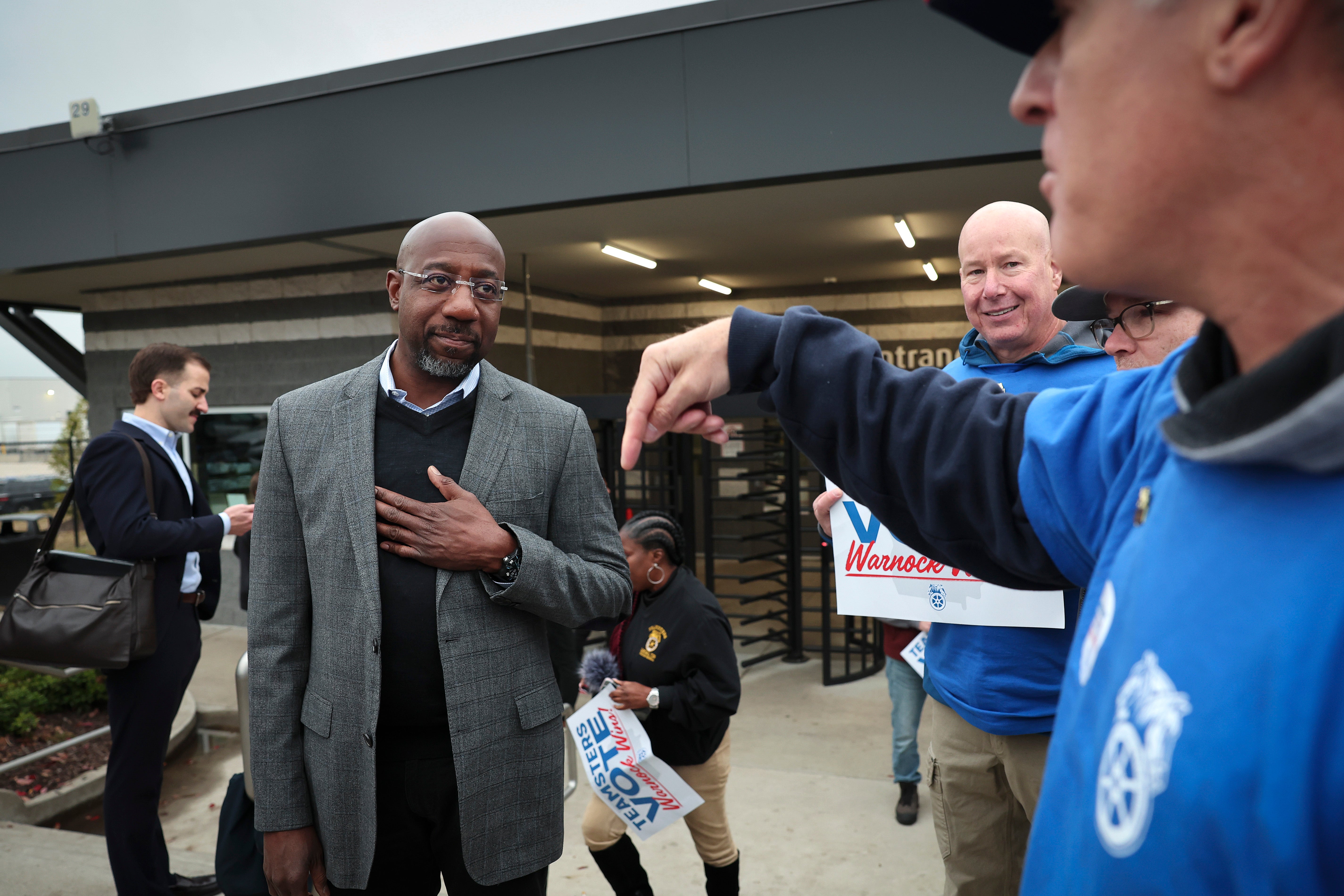 Georgia Democratic Senate candidate Raphael Warnock greets members of the Teamsters after speaking at a Get Out the Vote event at a UPS worksite 5 December 2022 in Atlanta, Georgia