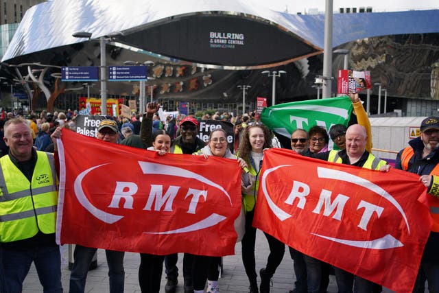 <p>Rail workers on a picket line at Birmingham New Street Station</p>
