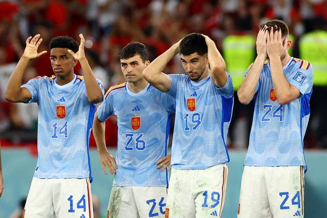 <p>Spain players look dejected after Sergio Busquets has his penalty saved</p>
