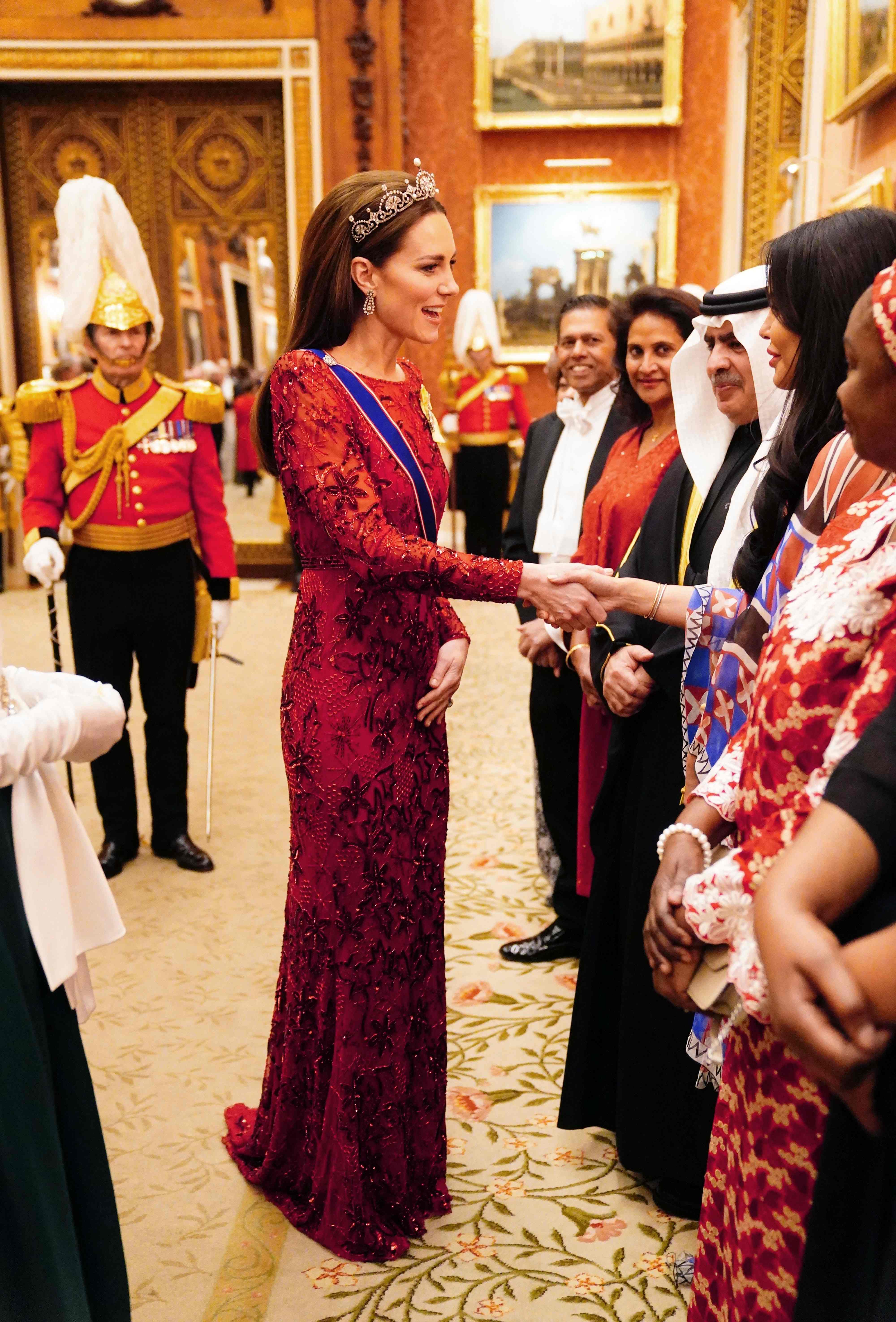 Kate, Princess of Wales, greets guests during a Diplomatic Corps reception at Buckingham Palace