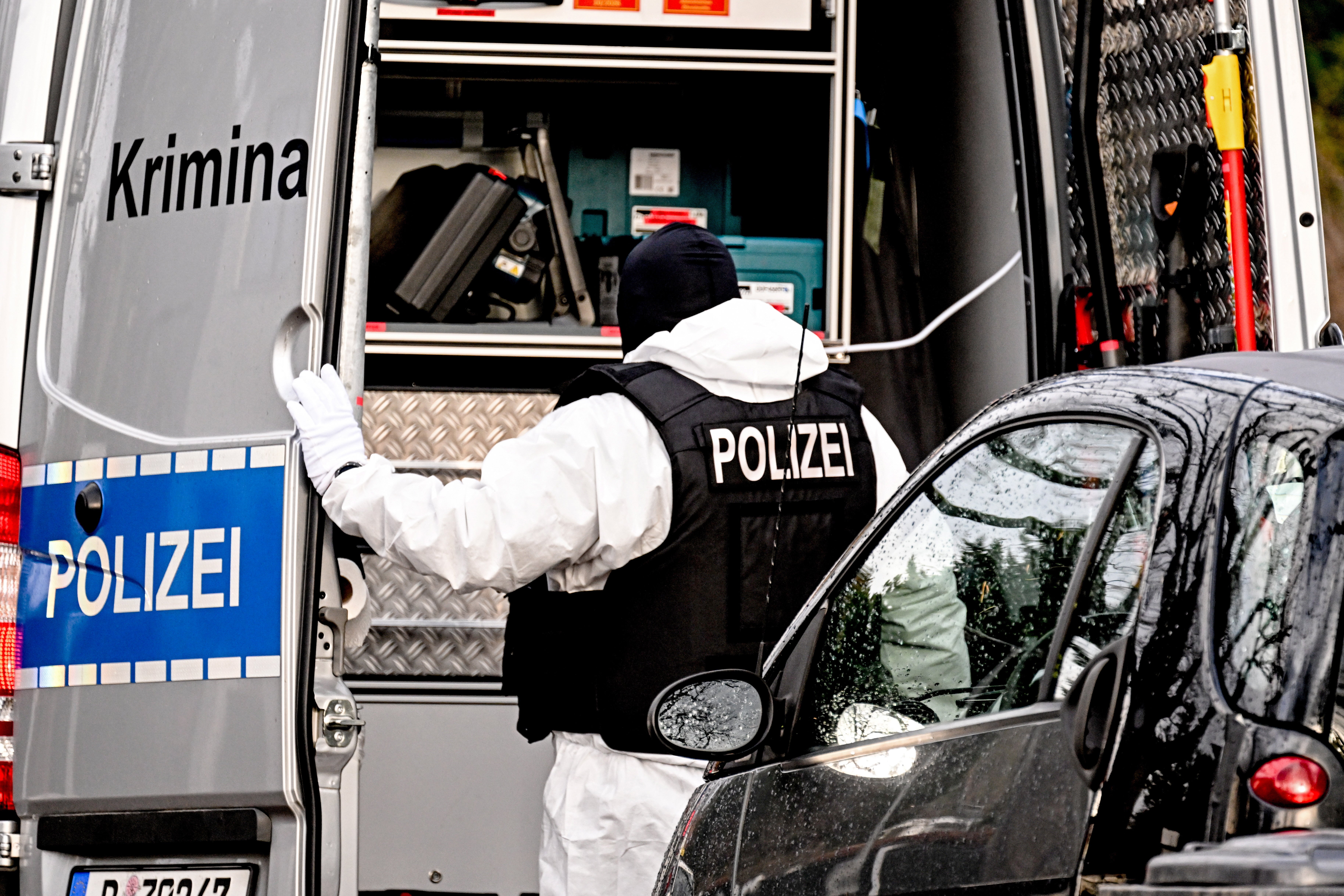 A police officer works during a raid in Berlin