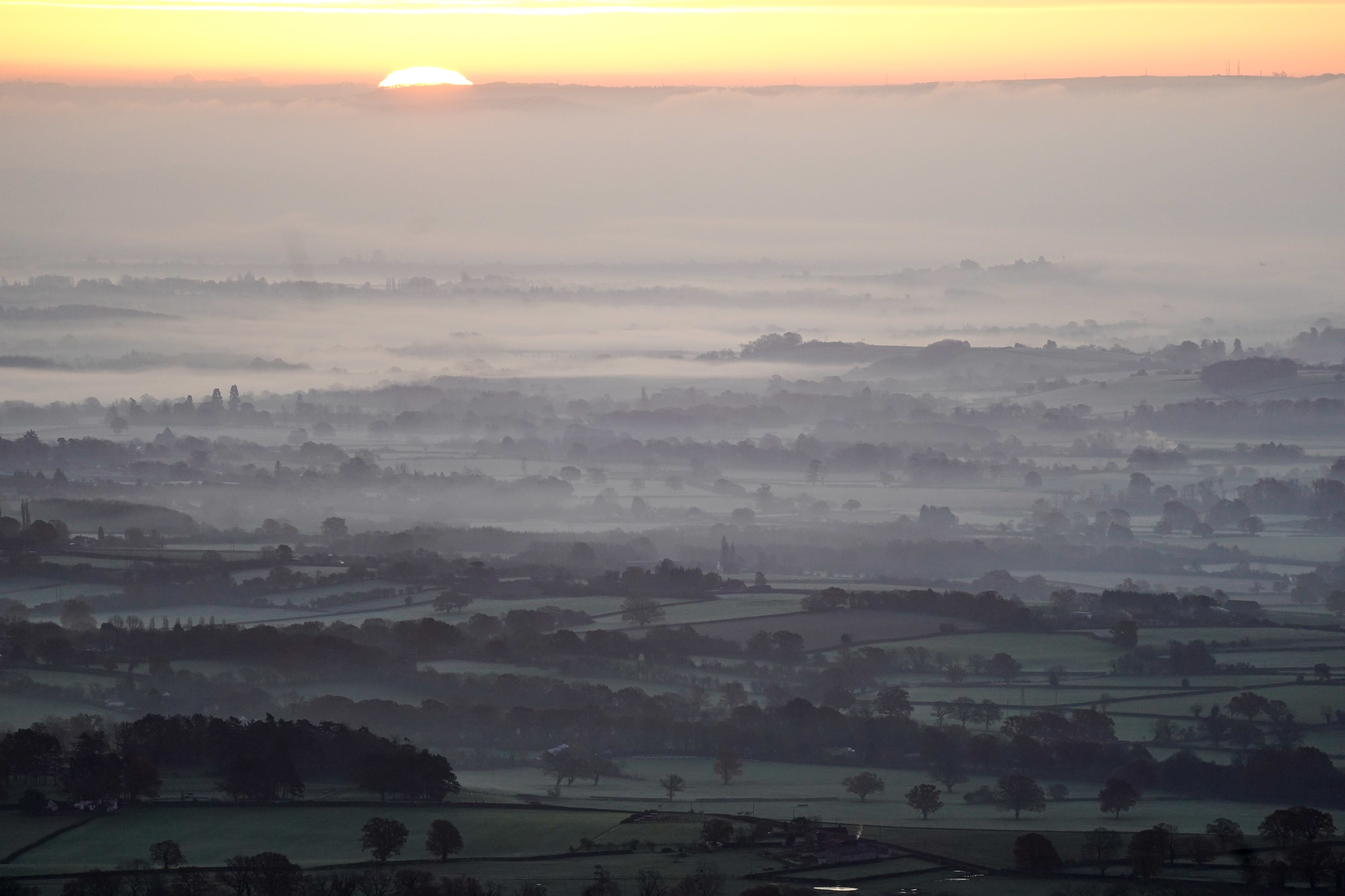 The sun rises over a foggy Worcestershire as seen from the Malvern Hills, with the UK is bracing itself for a week of very cold weather (Jacob King/PA)