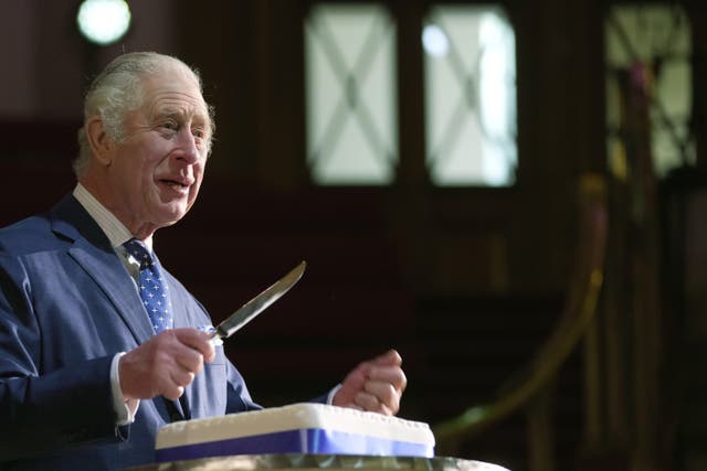 King Charles cuts a cake to celebrate the 40th anniversary of Business in the Community (Kin Cheung/PA)