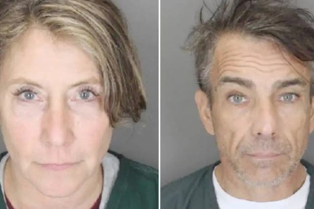 <p>Jacqueline Jewett and Raymond Bouderau during processing in Suffolk County. The pair were indicted by a grand jury for burglary and larceny charges after they allegedly stole more than $1m from a wealthy woman’s two homes</p>