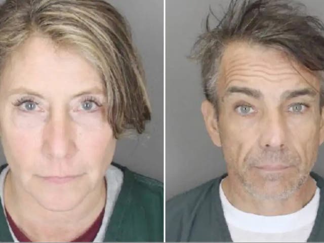 <p>Jacqueline Jewett and Raymond Bouderau during processing in Suffolk County. The pair were indicted by a grand jury for burglary and larceny charges after they allegedly stole more than $1m from a wealthy woman’s two homes</p>