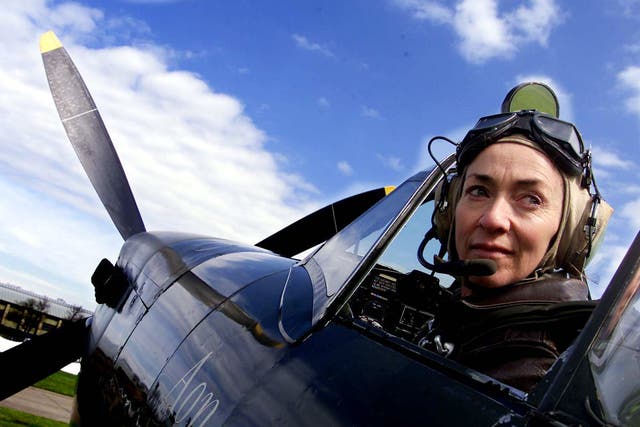 <p>Carolyn Grace in the cockpit of the Spitfire she flew in airshows</p>