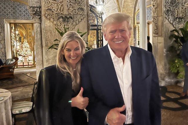 <p>Prominent QAnon and Pizzagate conspiracy theorist Liz Crokin poses with Donald Trump at Mar-a-Lago on 7 December.</p>