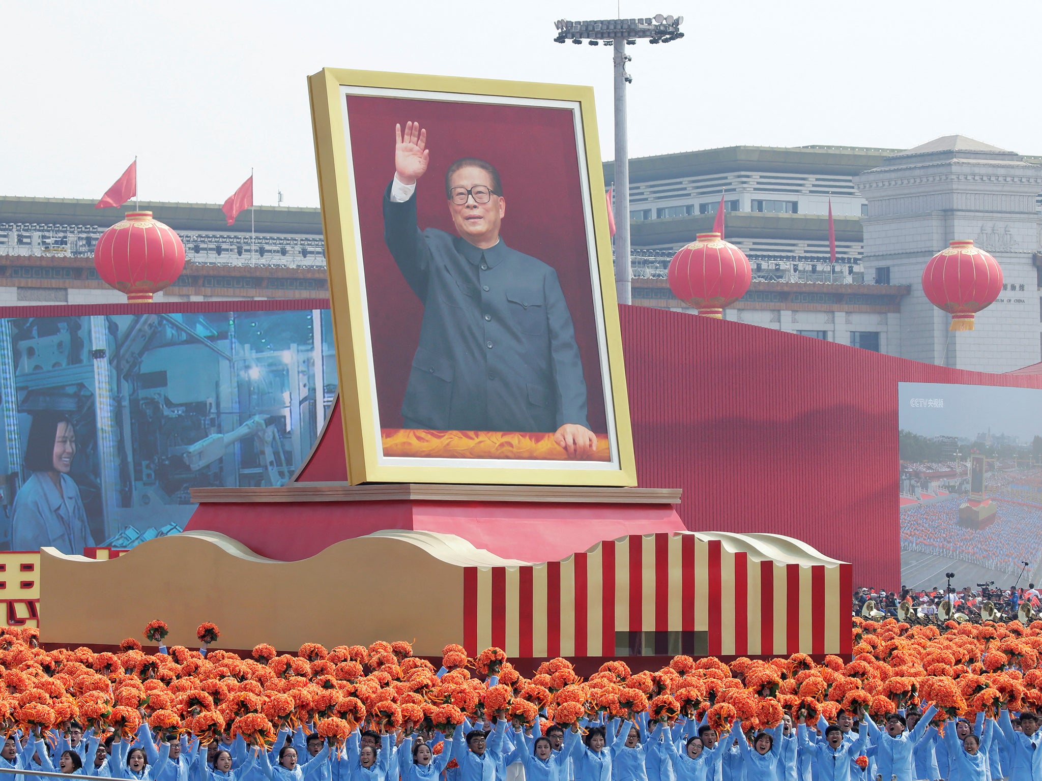 Performers travel past Tiananmen Square next to a float showing Jiang during a parade marking the 70th founding anniversary of the People’s Republic of China, in 2019