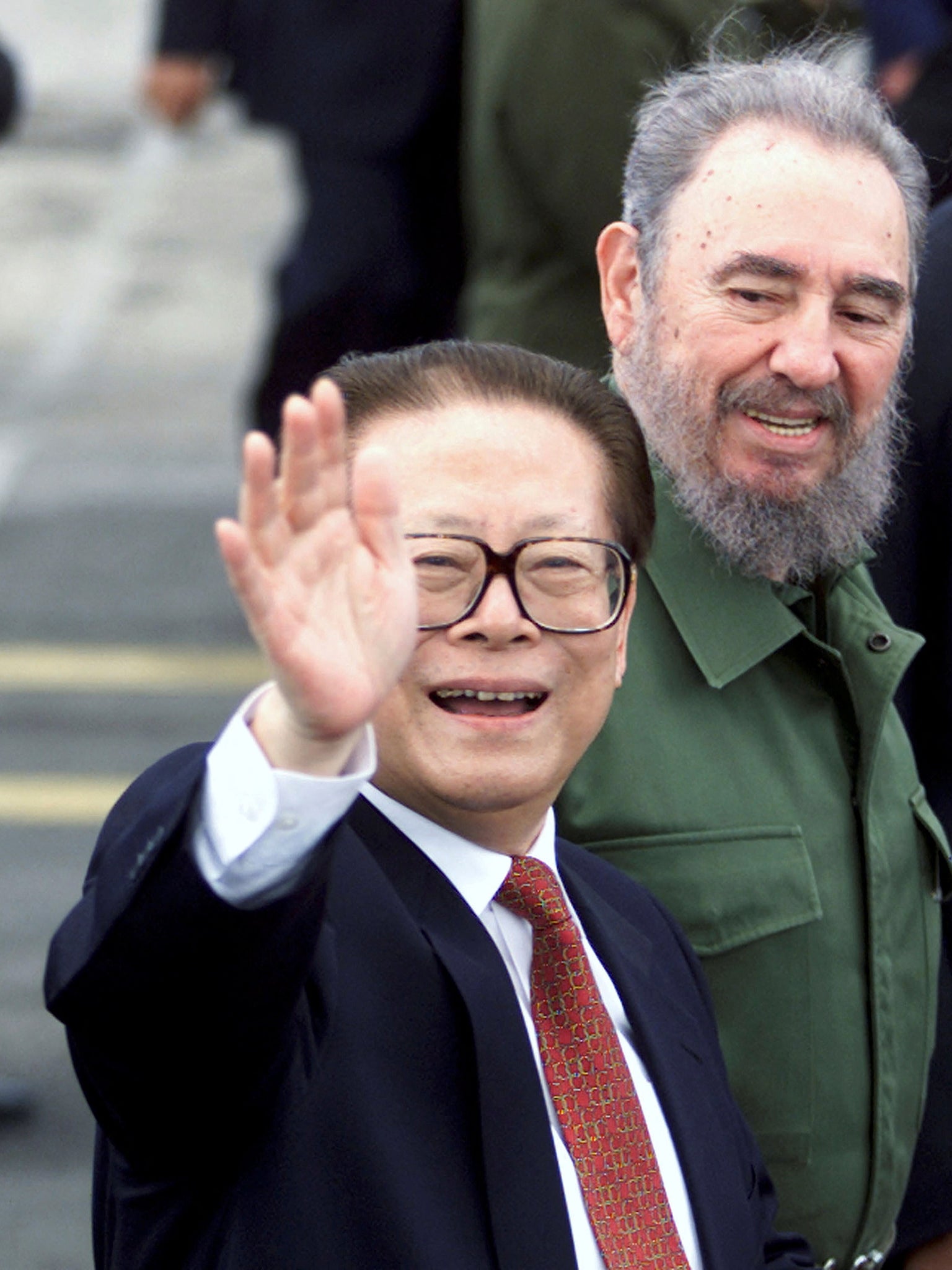 Jiang waves to the crowds after he was met by Cuba’s President Fidel Castro at Havana airport