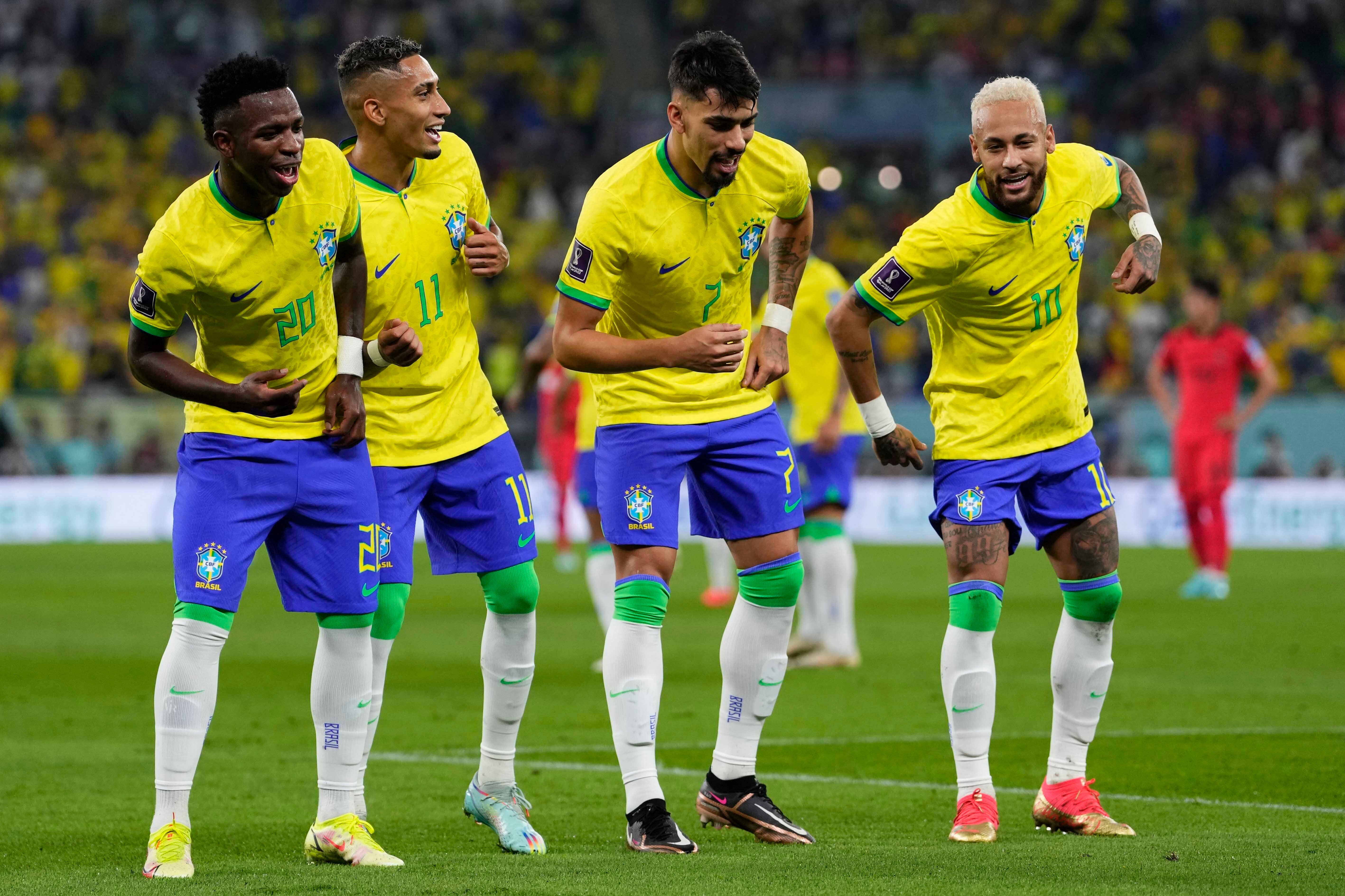Brazil’s players dance as they celebrate scoring against South Korea