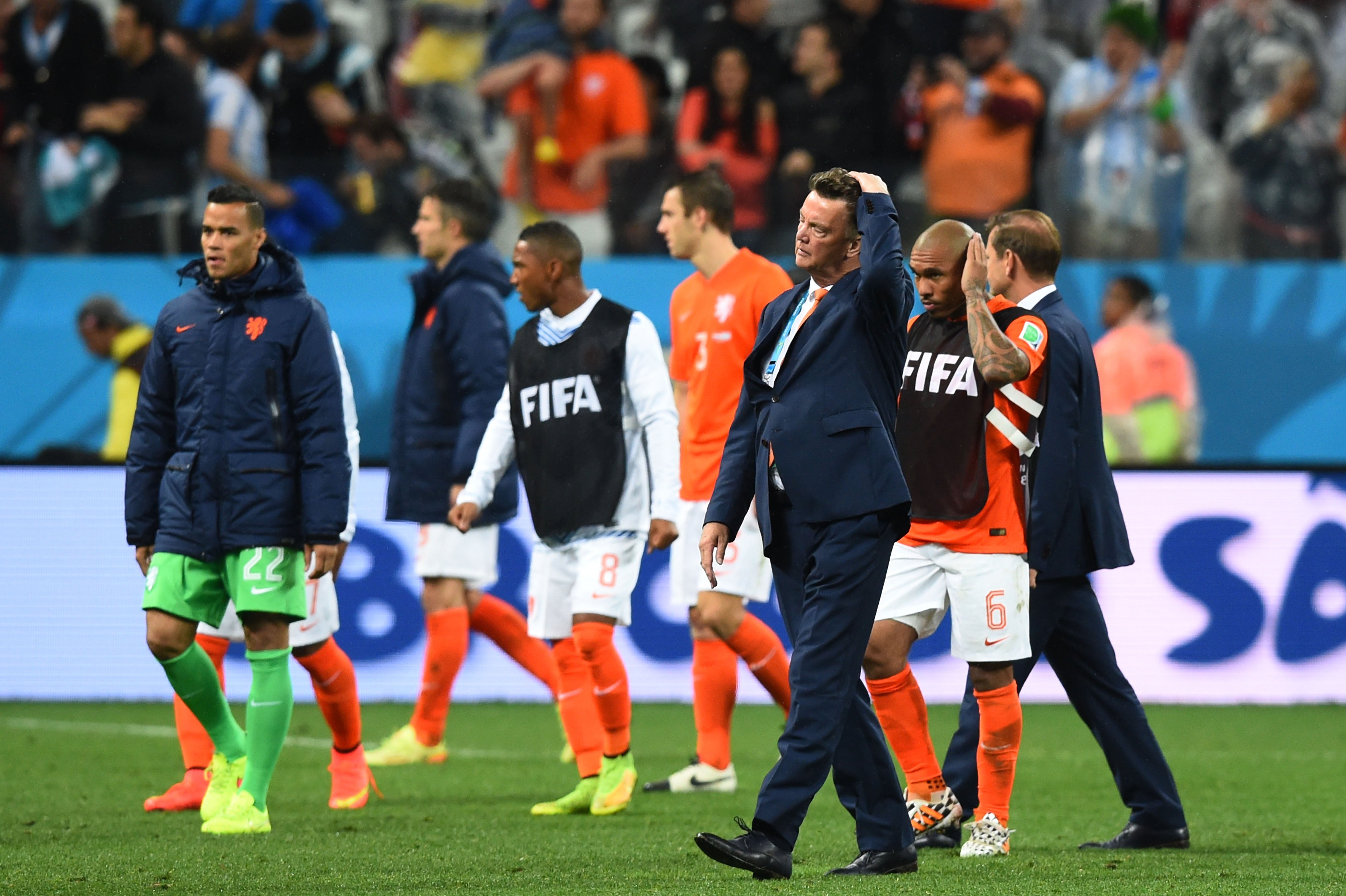 Louis van Gaal and his players after a shootout defeat by Argentina in the 2014 semi-finals