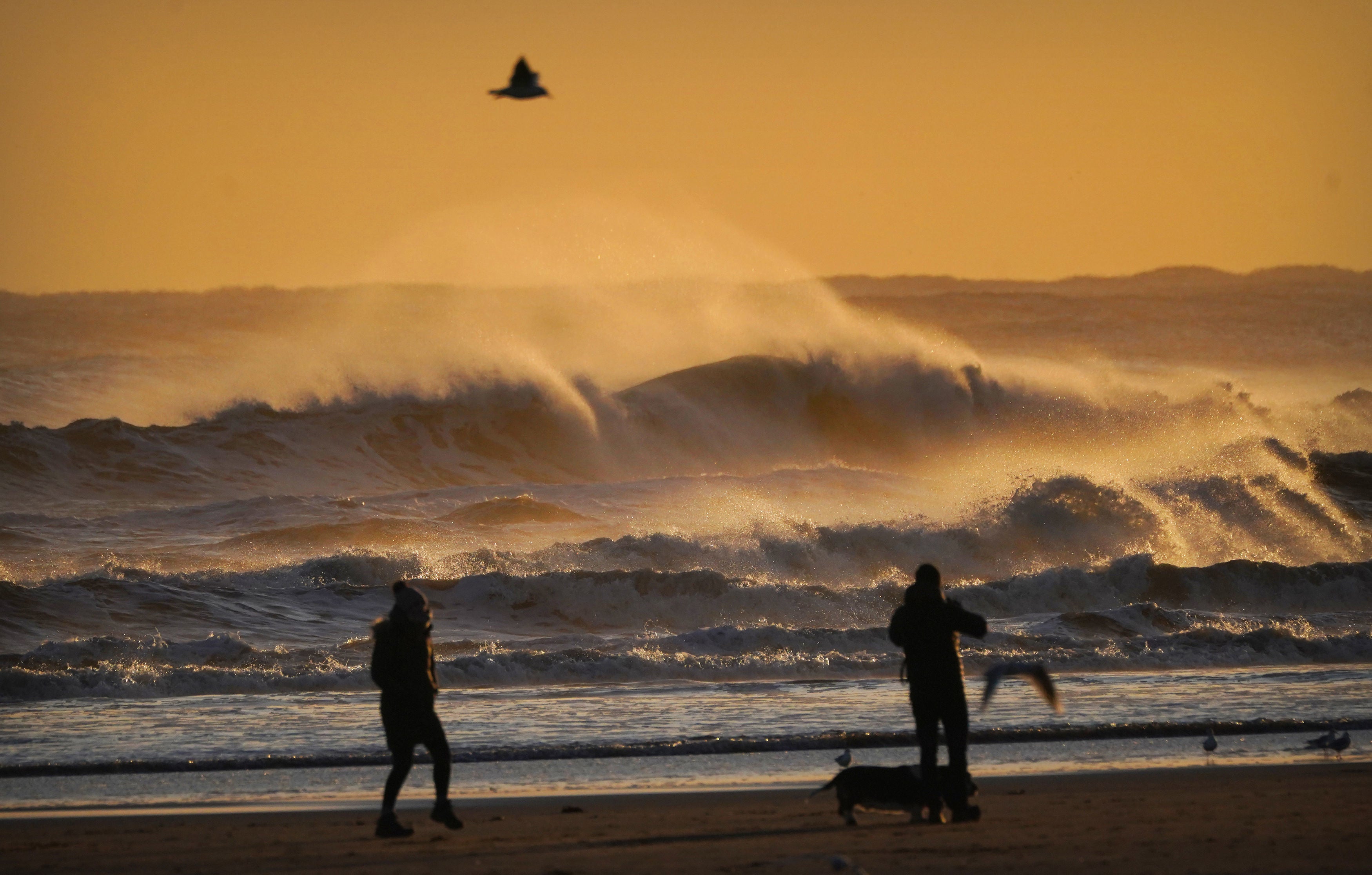 Walkers on Tynemouth beach on England’s northeast coast on Thursday