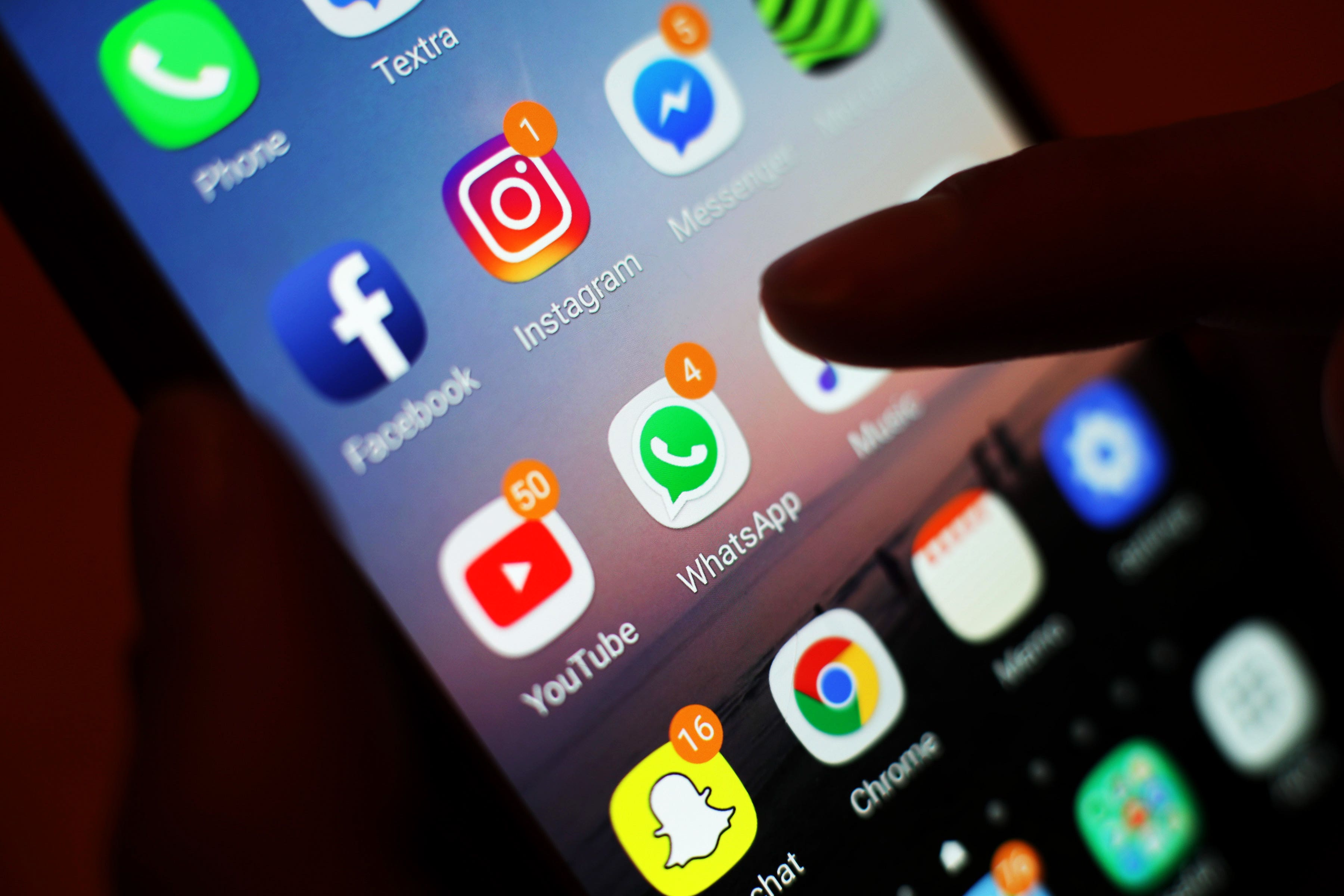 Social media apps, including Facebook, Instagram, YouTube and WhatsApp, displayed on a mobile phone screen (PA)