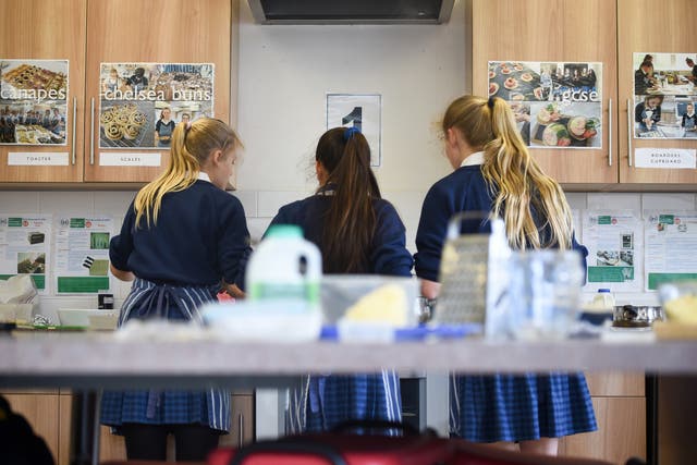 Students wear aprons in a cookery lesson in food technology class (Ben Birchall/PA)