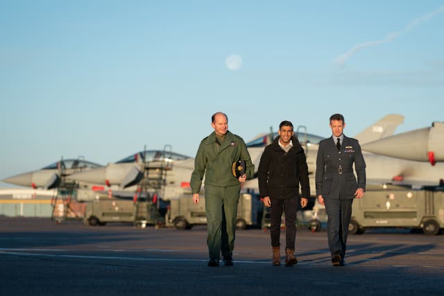 <p>Air Chief Marshal Mike Wigston (left) and Station Commander for RAF Coningsby Billy Cooper (right) with Prime Minister Rishi Sunak during his visit to RAF Coningsby in Lincolnshire. (Joe Giddens/ PA)</p>