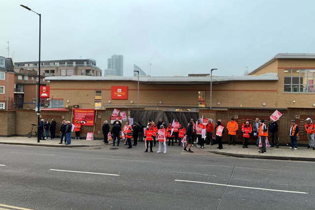 Striking postal workers outside the Royal Mail Islington Delivery Office in north London (Lucas Cumiskey/PA)