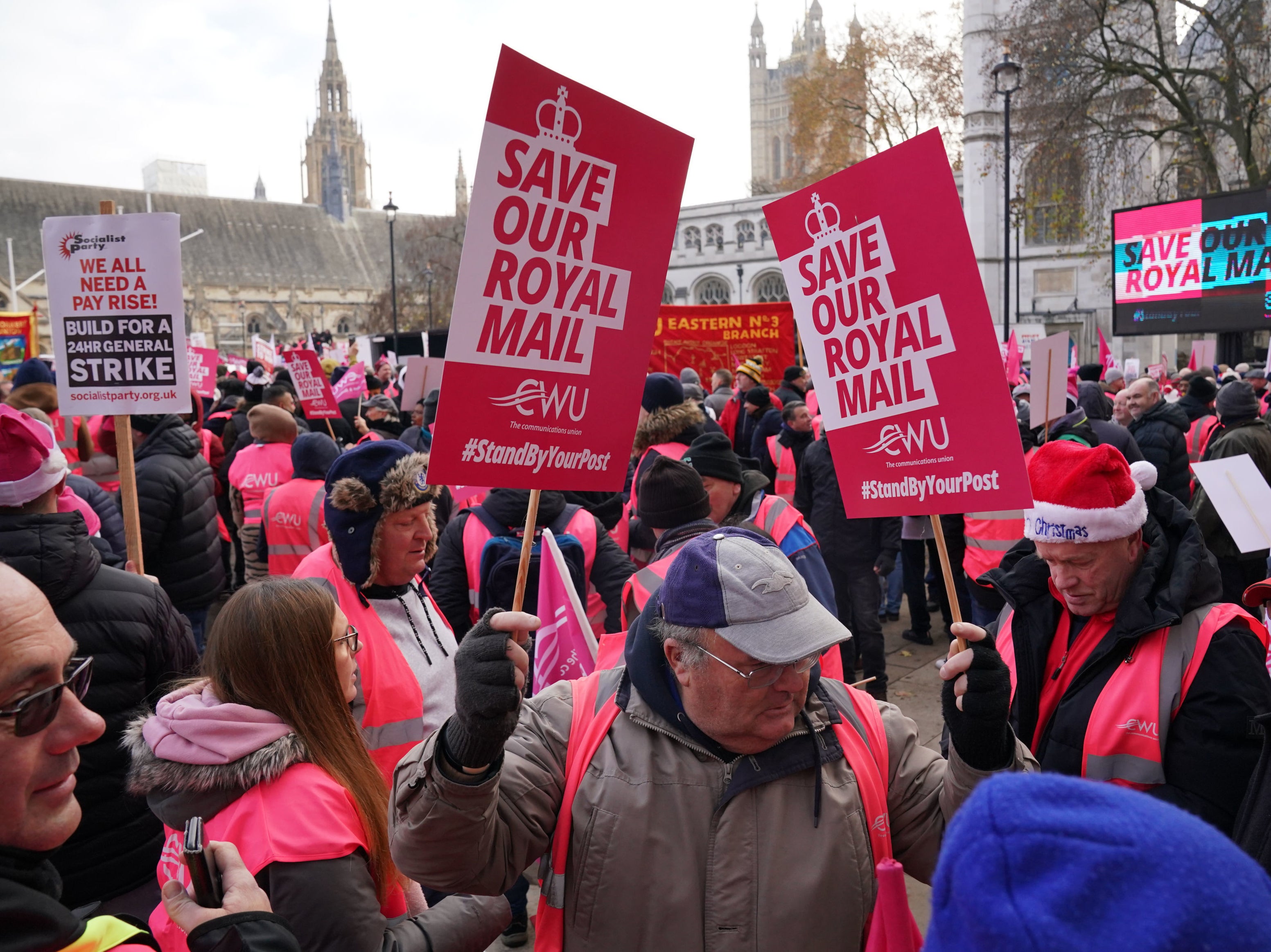 Striking postal workers brandish placards reading ‘Save Our Royal Mail’ at Parliament Square rally