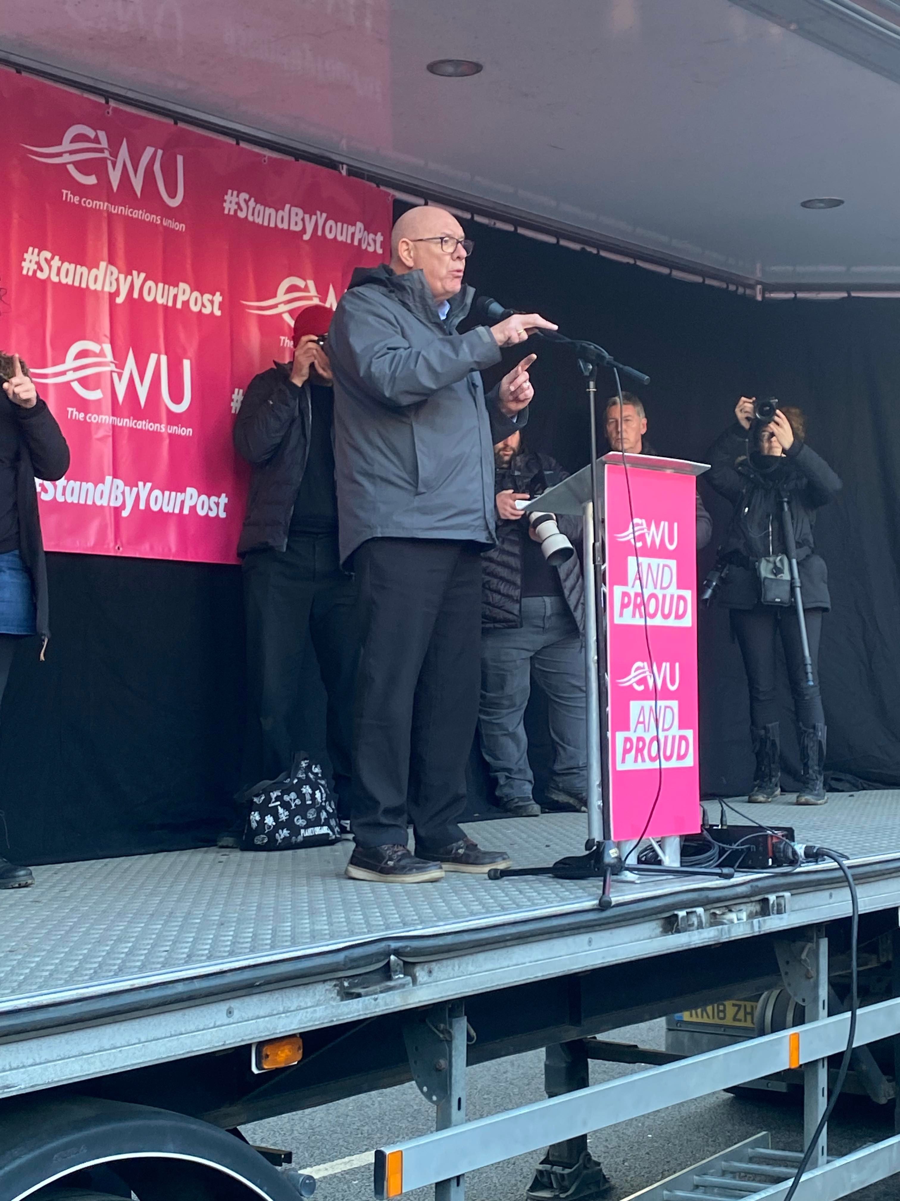 General Secretary of the Communication Workers Union Dave Ward addresses striking workers on stage at Parliament Square rally on 9 December.