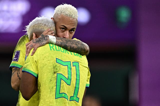 <p>Brazil’s forward Neymar comforts Brazil’s forward Rodrygo</p>