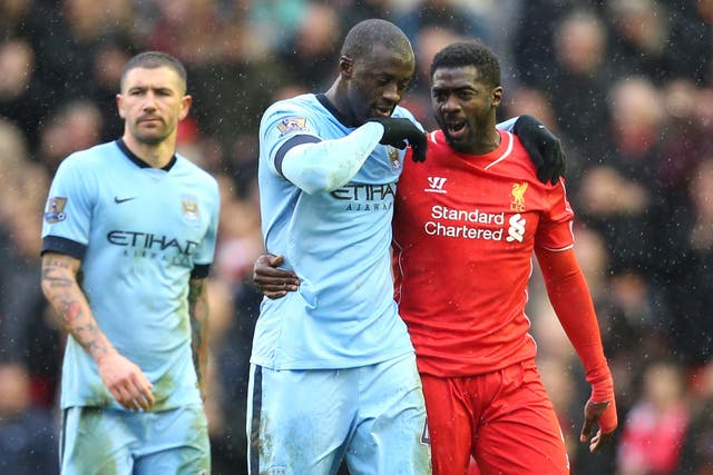 Kolo Toure (right) and brother Yaya (left) during their playing days at Liverpool and Manchester City respectively (Lynne Cameron/PA).
