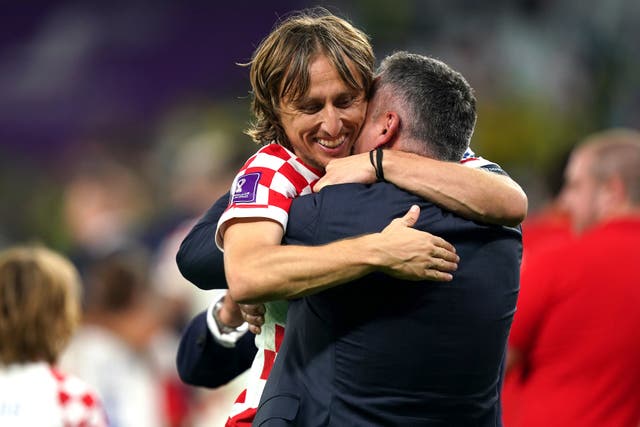 <p>Luka Modric is hugged after the full-time whistle </p>