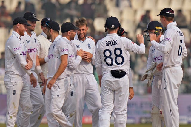 England’s Joe Root, centre, celebrates with team-mates after taking the wicket of Pakistan’s Muhammad Ali, right, during the second day of the second test cricket match between Pakistan and England, in Multan, Pakistan, Saturday, Dec. 10, 2022. (AP Photo/Anjum Naveed)