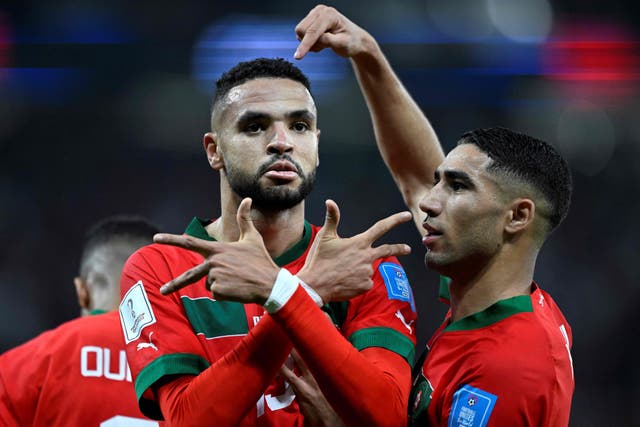 <p>Morocco’s forward Youssef En-Nesyri celebrates scoring  with Achraf Hakimi</p>