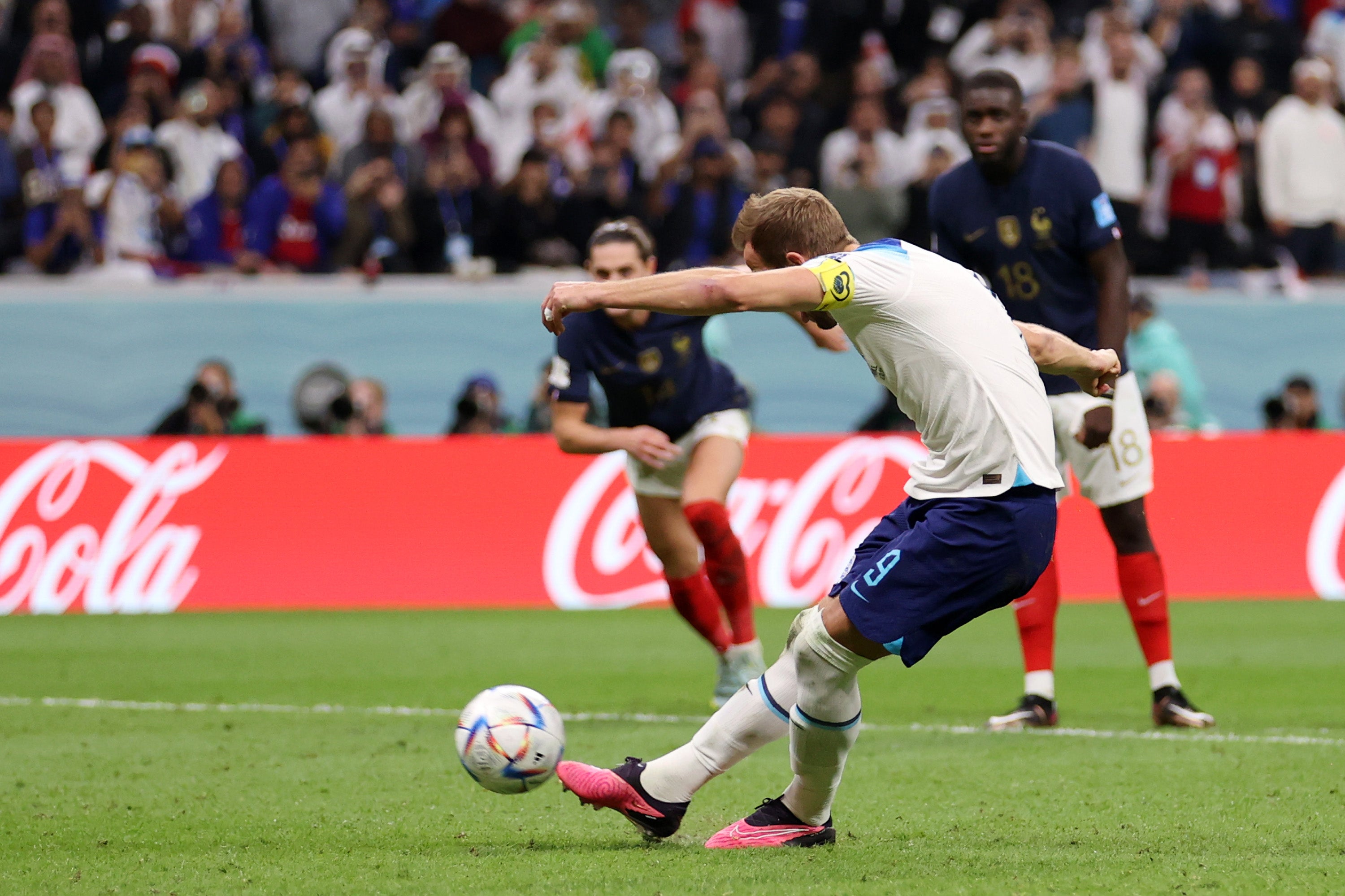 Harry Kane scores their first goal from the penalty spot past France's Hugo Lloris