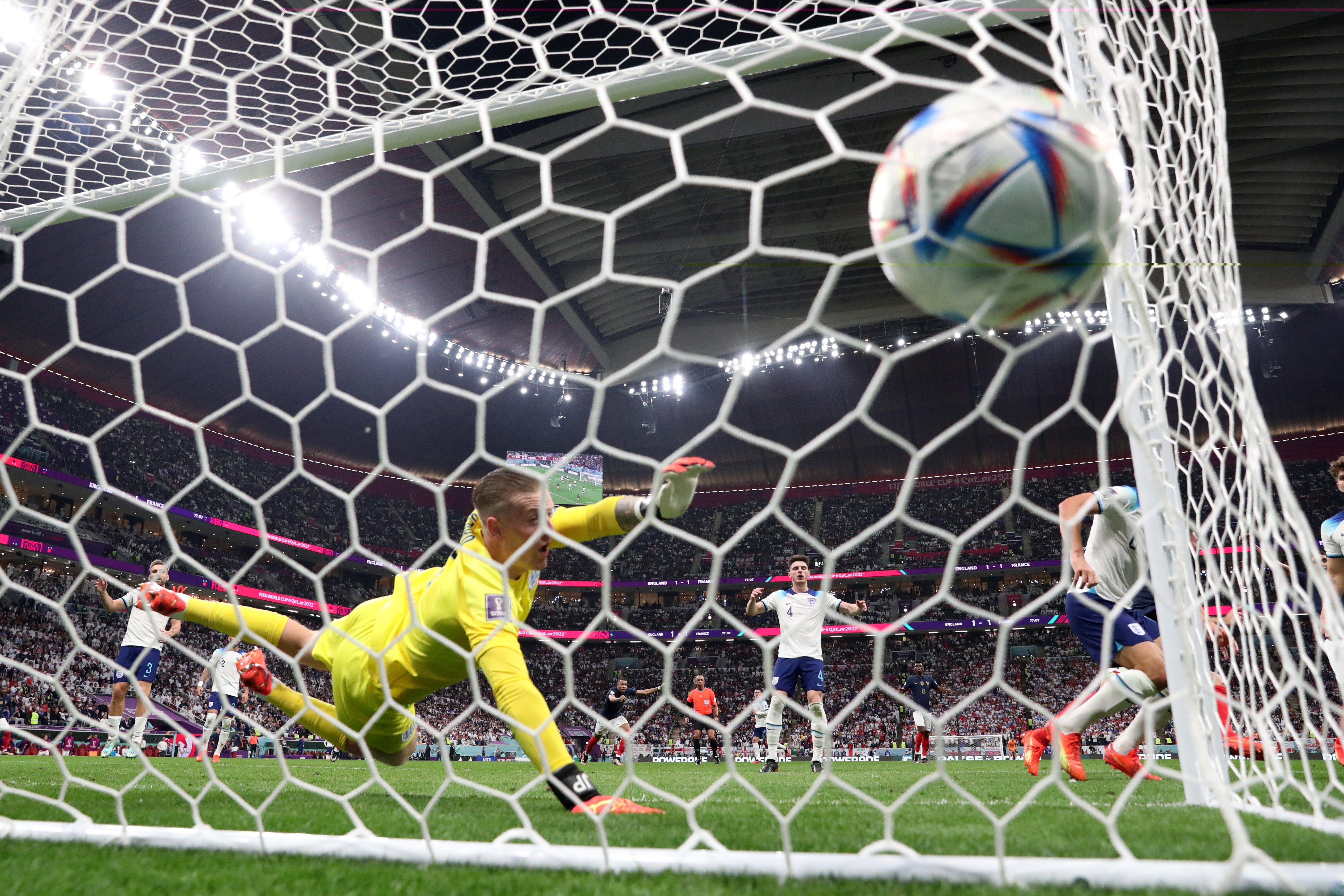 Jordan Pickford of England dives in vain as Olivier Giroud of France scores the team's second goal