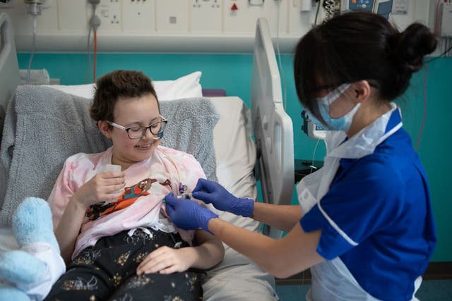 <p>A senior research nurse administers the new therapy to Alyssa </p>