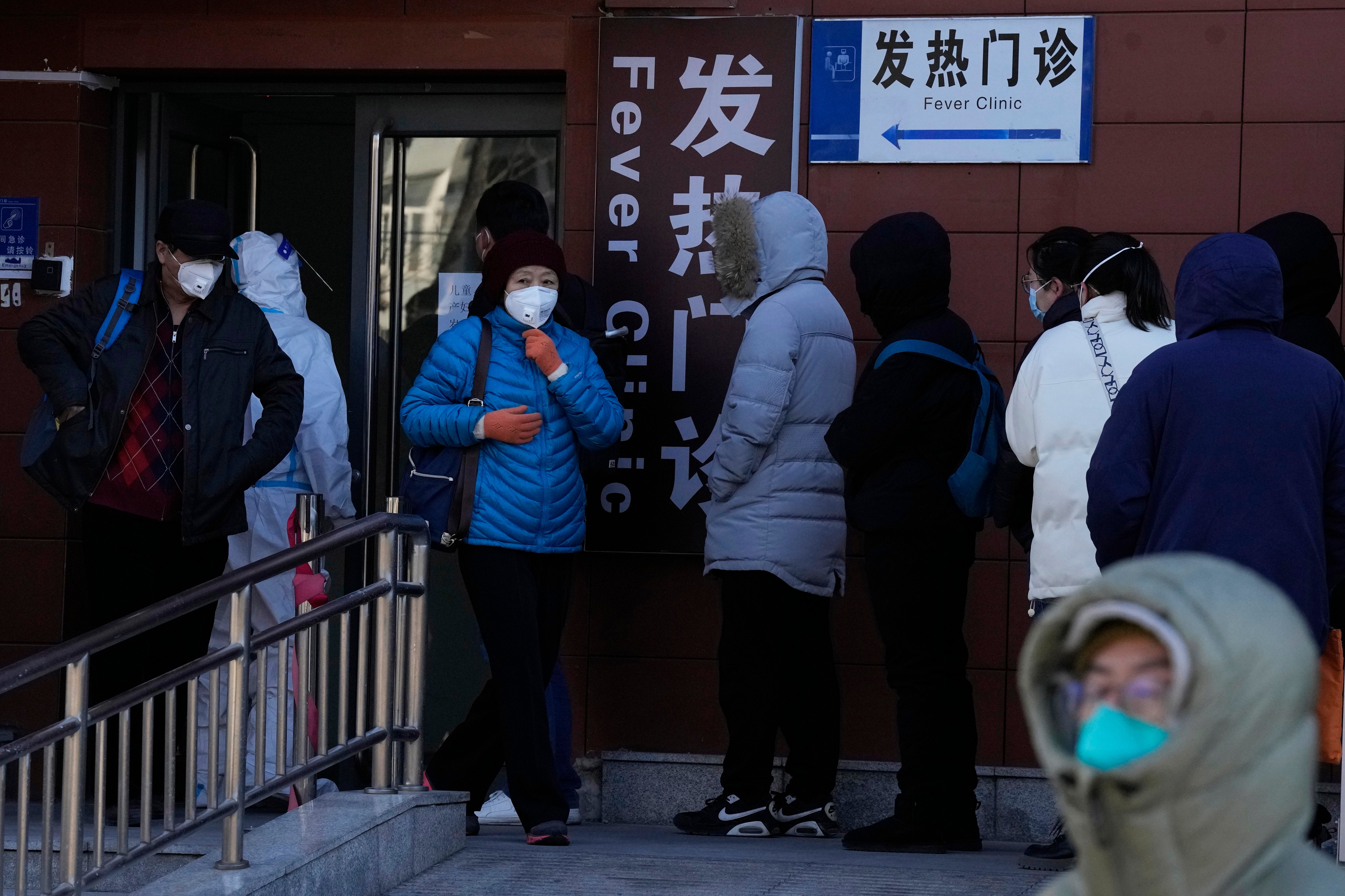 Residents line up outside the fever clinic at a hospital in Beijing, Saturday, 10 December 2022