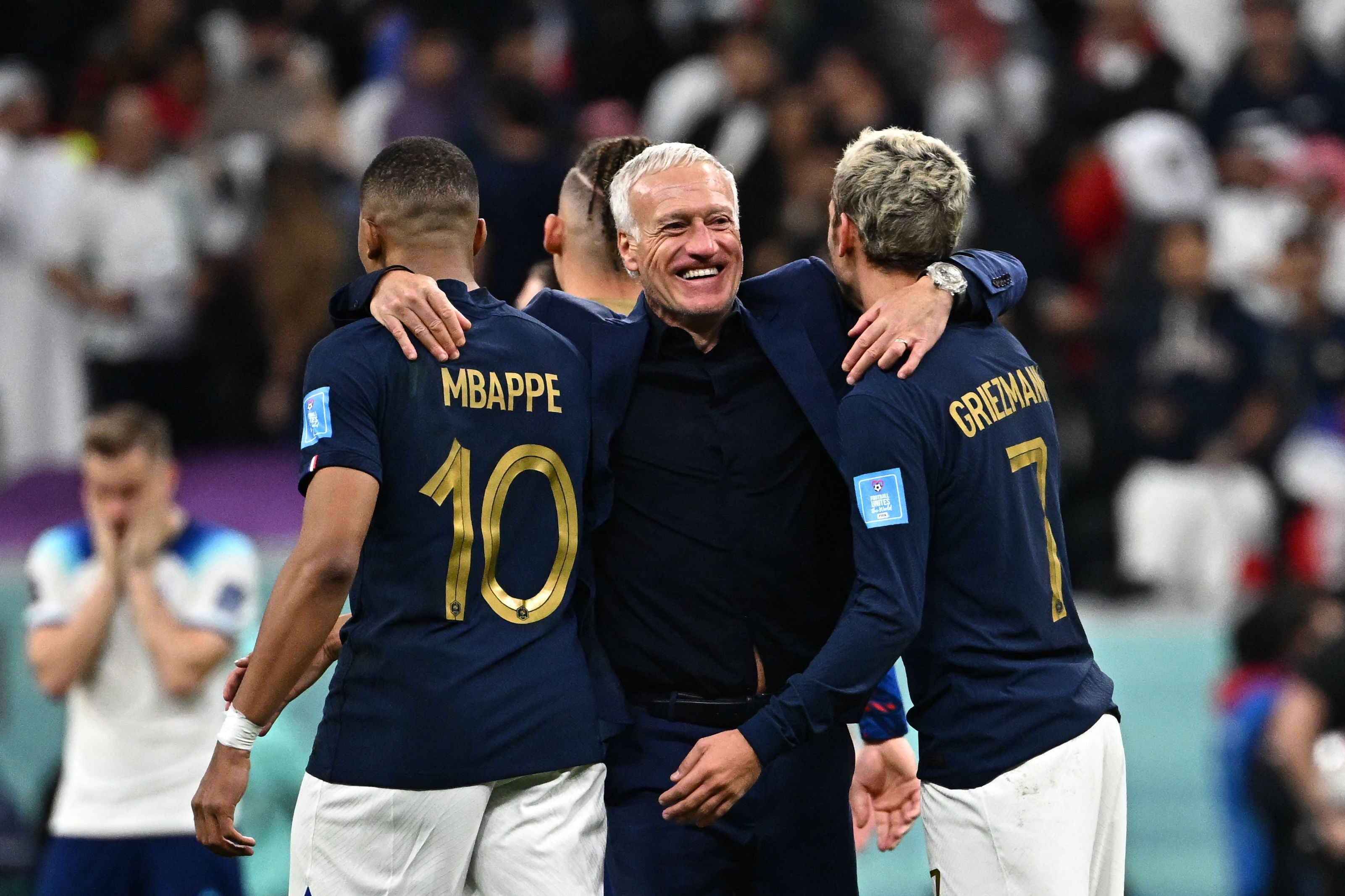 Didier Deschamps celebrates with Kylian Mbappe and Antoine Griezmann