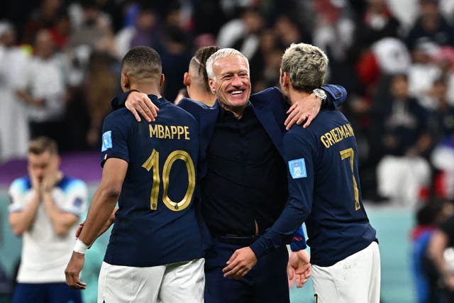 <p>Didier Deschamps celebrates with Kylian Mbappe and Antoine Griezmann</p>