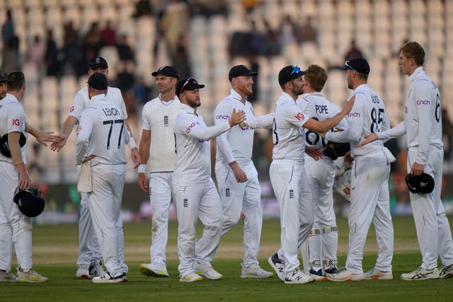 England’s players shake hands on end of third day of play (Anjum Naveed/AP)