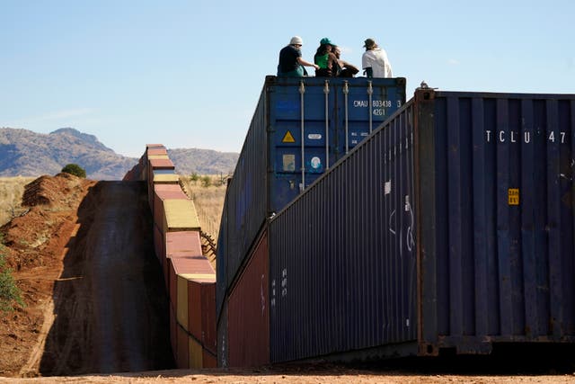 <p>Activists sit on newly installed shipping containers along the border creating a wall between the United States and Mexico in San Rafael Valley, Arizona </p>