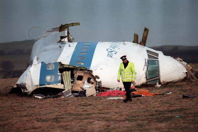 <p>This photo taken on December 22, 1988 shows a policeman walking away from the remains of the 747 Pan Am airliner that exploded and crashed over Lockerbie, Scotland</p>